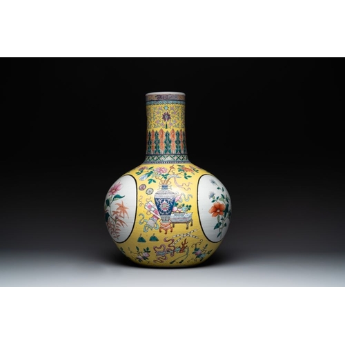 291 - A large Chinese famille rose yellow-ground 'tianqiu ping' vase with flowers and antiquities, 19th C.... 