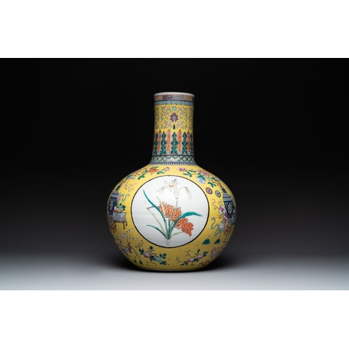 291 - A large Chinese famille rose yellow-ground 'tianqiu ping' vase with flowers and antiquities, 19th C.... 