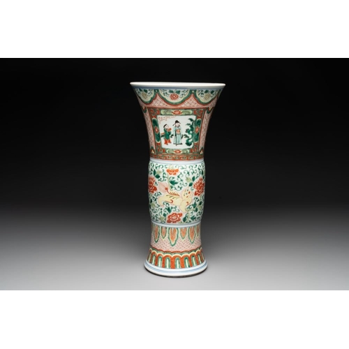 297 - A Chinese wucai 'gu' vase with Buddhist lions, peony scrolls and figures, 19th C.H.: 43 cm... 