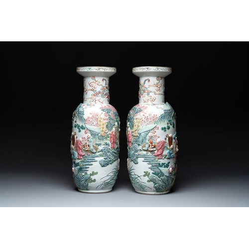 306 - A pair of Chinese famille rose '18 luohan' vases with relief design, 19th C.H.: 60 cm... 