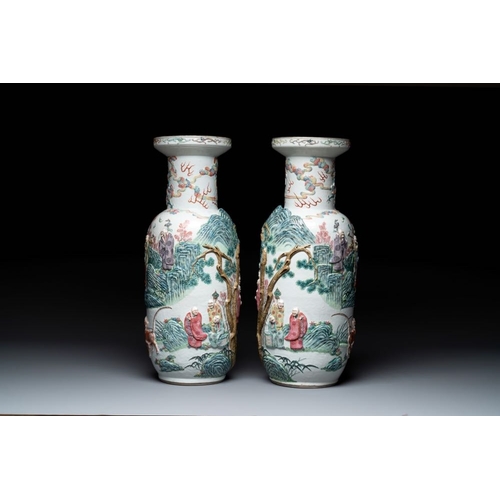 306 - A pair of Chinese famille rose '18 luohan' vases with relief design, 19th C.H.: 60 cm... 