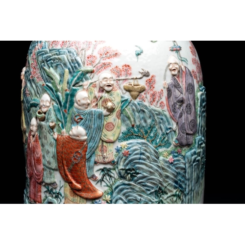 306 - A pair of Chinese famille rose '18 luohan' vases with relief design, 19th C.H.: 60 cm... 