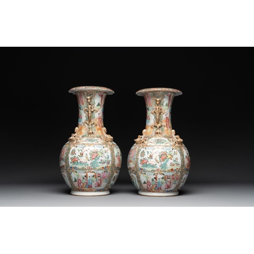 311 - A pair of Chinese Canton famille rose vases with narrative design, 19th C.H.: 36 cm... 