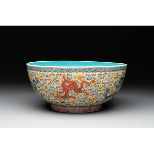 337 - A Chinese famille rose turquoise-and-yellow-ground 'dragon' bowl on wooden stand, Qianlong mark, Rep... 