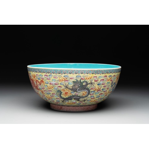 337 - A Chinese famille rose turquoise-and-yellow-ground 'dragon' bowl on wooden stand, Qianlong mark, Rep... 