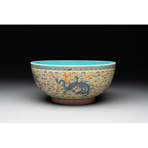 337 - A Chinese famille rose turquoise-and-yellow-ground 'dragon' bowl on wooden stand, Qianlong mark, Rep... 