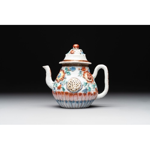 480 - A Chinese famille rose teapot and stand with floral relief design, QianlongDia.: 16,5 cm (the stand)... 