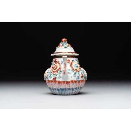 480 - A Chinese famille rose teapot and stand with floral relief design, QianlongDia.: 16,5 cm (the stand)... 