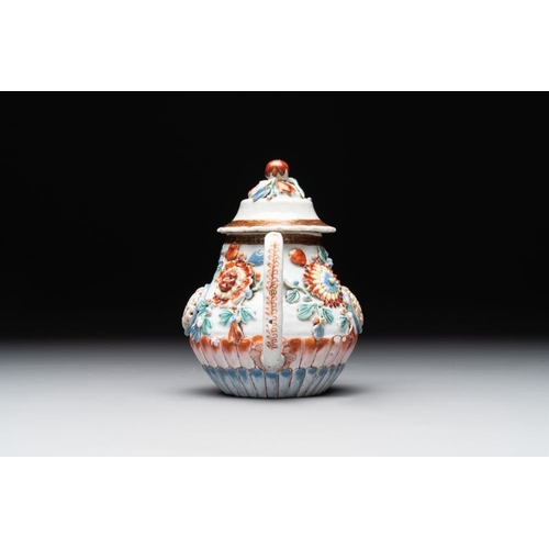 480 - A Chinese famille rose teapot and stand with floral relief design, QianlongDia.: 16,5 cm (the stand)... 