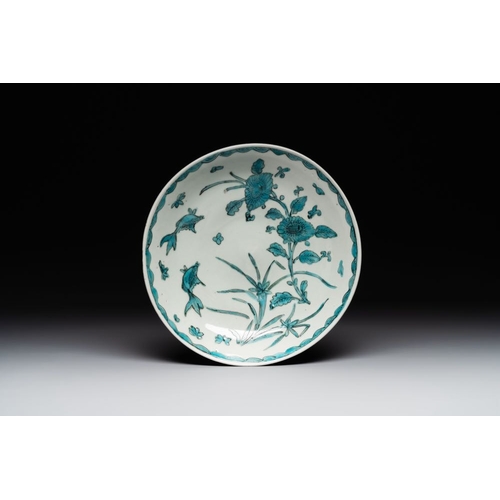 50 - A Chinese Swatow turquoise- and black-enamelled 'carp, narcissus and chrysanthemum' plate and a tomo... 