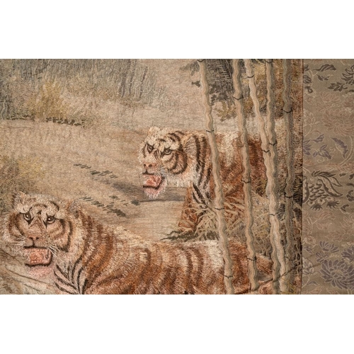 547 - A Japanese embroidered silk wall tapestry with two tigers, Meiji, 19th C.Dim.: 132,5 x87,5 cm... 