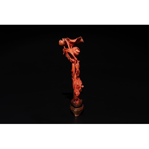 676 - A Chinese red coral figure of a standing lady holding a flower, 19/20th C.H.: 15,5 cm (incl. stand) ... 