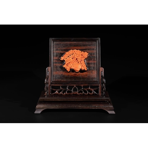 682 - A Chinese silver-inlaid hardwood table screen with a red coral carving of a flower basket, 19/20th C... 