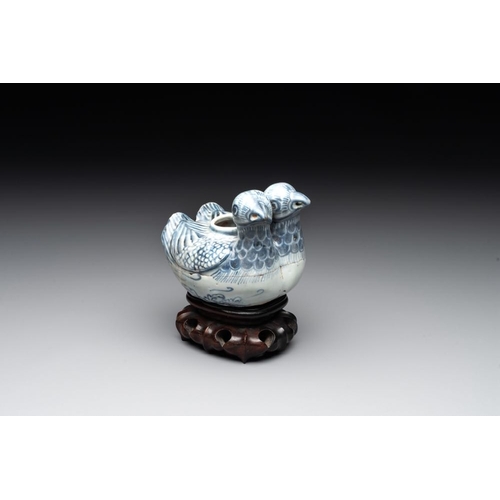 71 - A Chinese blue and white 'double mandarin duck' ewer or water dropper on wooden stand, Ming, ca. 150... 