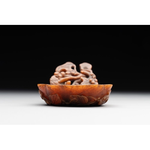 715 - A rare Chinese carved rhinoceros horn 'libation cup' with grape design, 17/18th C.Dim.: 11,5 x 6 x 4... 