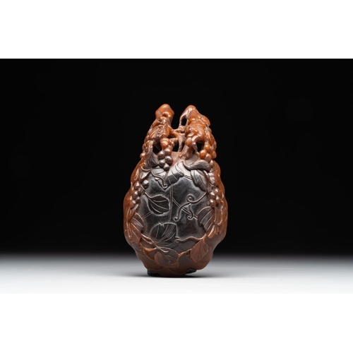 715 - A rare Chinese carved rhinoceros horn 'libation cup' with grape design, 17/18th C.Dim.: 11,5 x 6 x 4... 