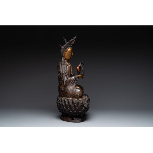 721 - An impressive and large Chinese partially lacquered and gilt bronze Guanyin on a lotus throne, MingH... 