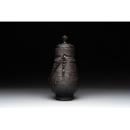 753 - A Chinese archaistic bronze 'Taotie' wine vessel and cover, 'you ', MingH.: 23 cm (incl. cover)
Weig... 