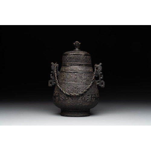 753 - A Chinese archaistic bronze 'Taotie' wine vessel and cover, 'you ', MingH.: 23 cm (incl. cover)
Weig... 