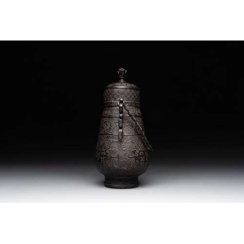 753 - A Chinese archaistic bronze 'Taotie' wine vessel and cover, 'you ', MingH.: 23 cm (incl. cover)
Weig... 