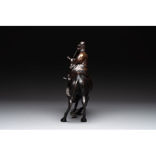 795 - A Chinese gold-splashed bronze incense burner in the shape of an immortal riding a buffalo, 19th C.D... 