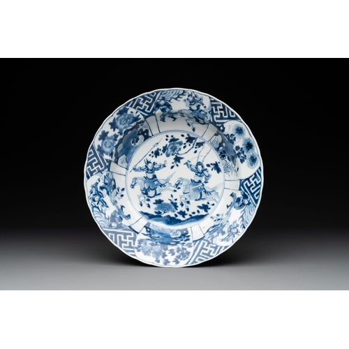 941 - A Chinese blue and white 'warriors on horseback' 'klapmuts' bowl, Kangxi mark and of the periodDia.:... 