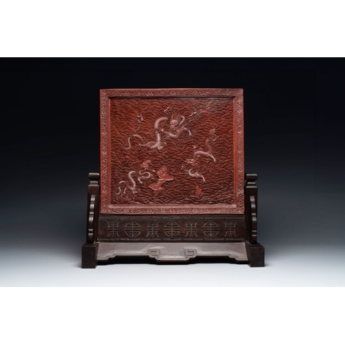 852 - A rectangular Chinese carved red lacquer 'dragon' table screen, later wooden stand, QianlongDim.: 59... 