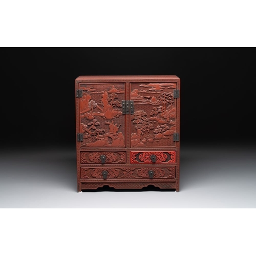 853 - A Chinese cinnabar lacquer 'mountainous landscape' cabinet, 19th C.Dim.: 38,5 x 17 x 43 cm... 