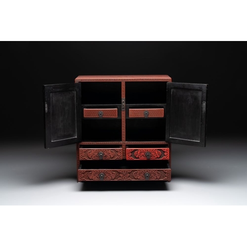 853 - A Chinese cinnabar lacquer 'mountainous landscape' cabinet, 19th C.Dim.: 38,5 x 17 x 43 cm... 