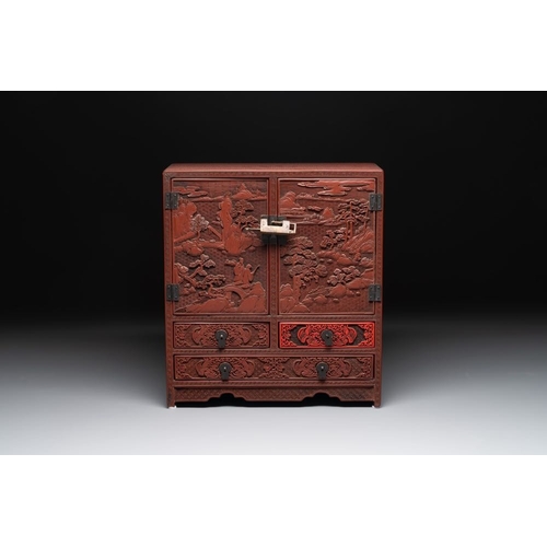 853 - A Chinese cinnabar lacquer 'mountainous landscape' cabinet, 19th C.Dim.: 38,5 x 17 x 43 cm... 