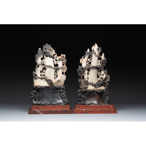 860 - A pair of Chinese carved soapstone groups and a painted alabaster and wood table screen depicting a ... 