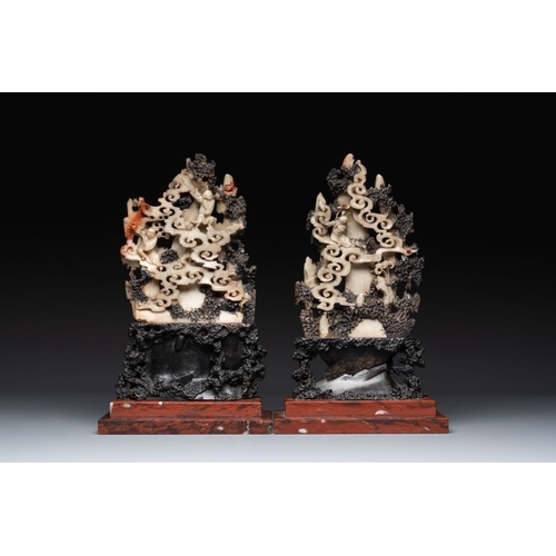 860 - A pair of Chinese carved soapstone groups and a painted alabaster and wood table screen depicting a ... 