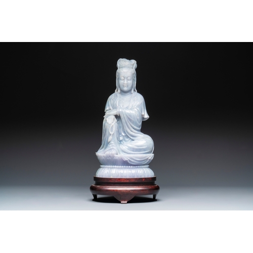 712 - An exceptional and large Chinese carved pale lavender jadeite Guanyin on a wooden stand, RepublicH.:... 