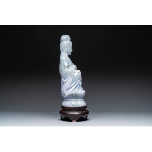 712 - An exceptional and large Chinese carved pale lavender jadeite Guanyin on a wooden stand, RepublicH.:... 