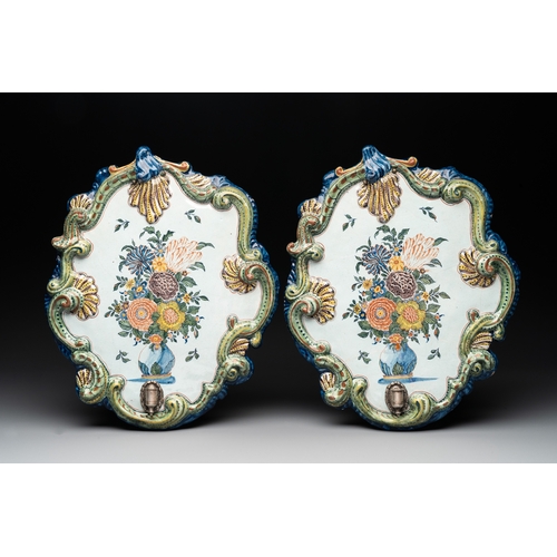 1018 - A pair of polychrome Dutch Delft plaques mounted as wall sconces with silver mounts, 18th C.Dim.: 35... 