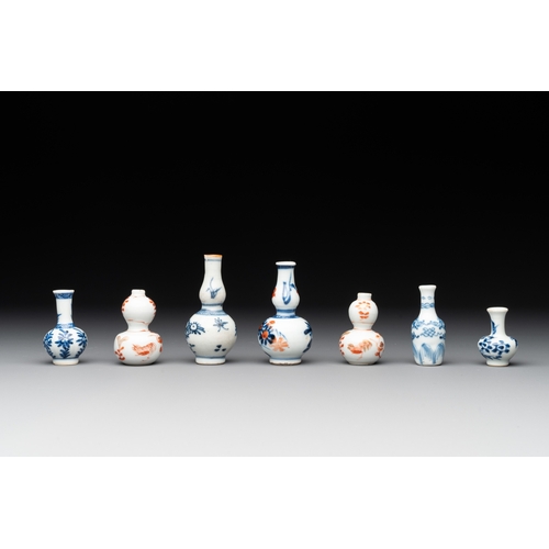 326 - Seven Chinese iron-red, blue and white miniature vases, KangxiH.: 7,2 cm (the tallest) H.: 3,7 cm (t... 