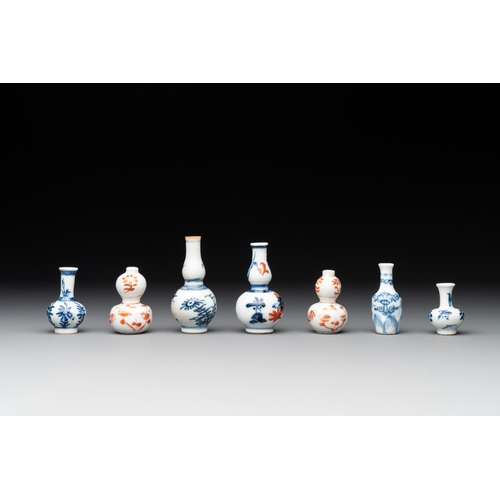 326 - Seven Chinese iron-red, blue and white miniature vases, KangxiH.: 7,2 cm (the tallest) H.: 3,7 cm (t... 