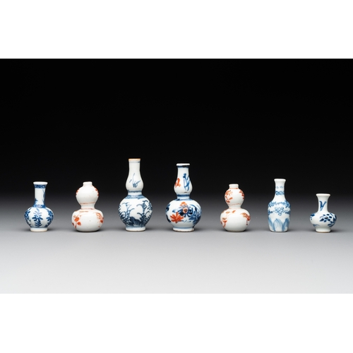 326 - Seven Chinese iron-red, blue and white miniature vases, KangxiH.: 7,2 cm (the tallest) H.: 3,7 cm (t... 