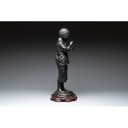 481 - A Japanese bronze sculpture of a boy feeding a bird on a wooden stand, signed, Meiji, 19th C.H.: 61,... 