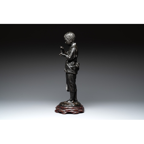 481 - A Japanese bronze sculpture of a boy feeding a bird on a wooden stand, signed, Meiji, 19th C.H.: 61,... 