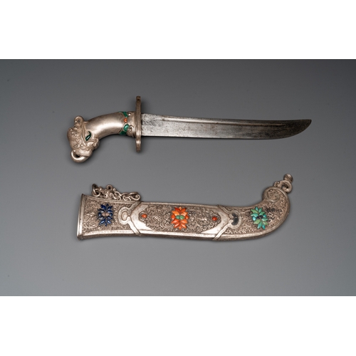 497 - A large Tibetan coral- and precious stone-inlaid silver dagger, 19th C.L.: 50,5 cm