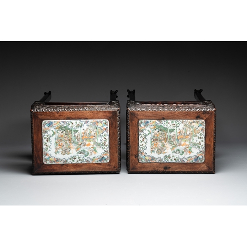 554 - A pair of Chinese famille verte 'narrative' plaques mounted in hardwood tables, 19th C.Dim.: 42 x 31... 