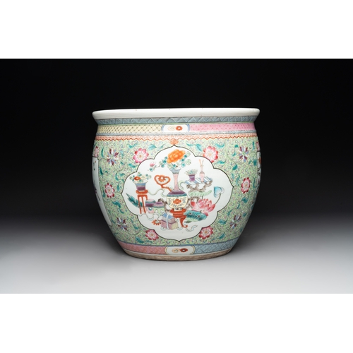 560 - A Chinese famille rose lime-green-ground jardiniÃ¨re with birds, flowers and antiquities, 19th C.Dia... 