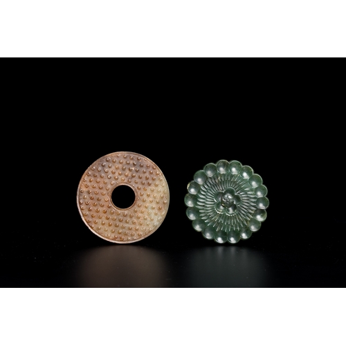 735 - A Chinese russet jade 'bi' disc and a spinach green flower-shaped pendant on wooden stands, Ming and... 