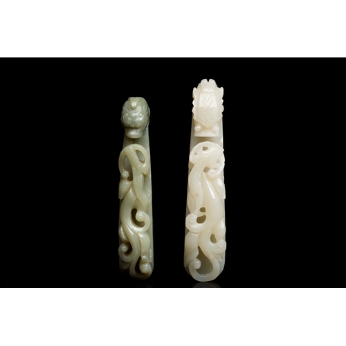 736 - Two Chinese white and celadon jade belt hooks, QingL.: 13,5 cm (the largest) L.: 12 cm (the smallest... 