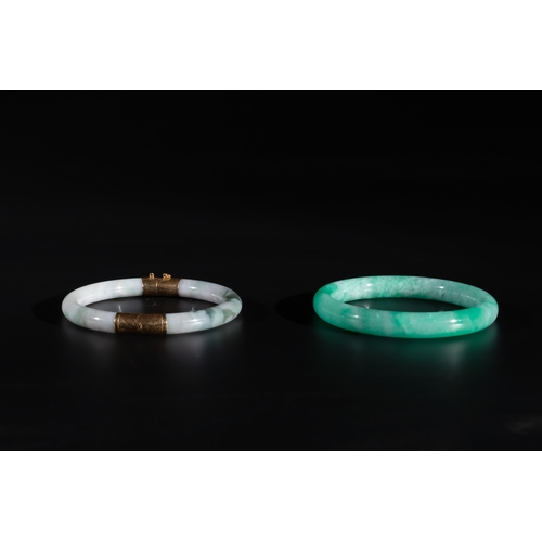 744 - Two Chinese jadeite bracelets, one with 14K gold mounts, 19/20th C.Dia.: 7,4 cm (the largest) Dia.: ... 