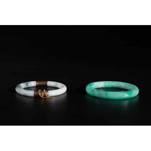 744 - Two Chinese jadeite bracelets, one with 14K gold mounts, 19/20th C.Dia.: 7,4 cm (the largest) Dia.: ... 