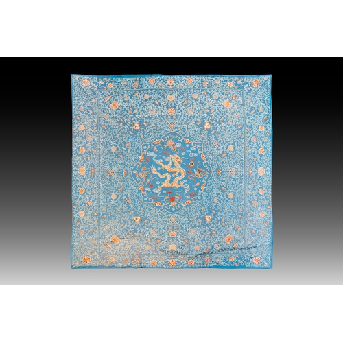 818 - A Chinese blue-ground embroidered silk panel with a dragon among bajixiang, 19th C.Dim.: 214,5 x 214... 