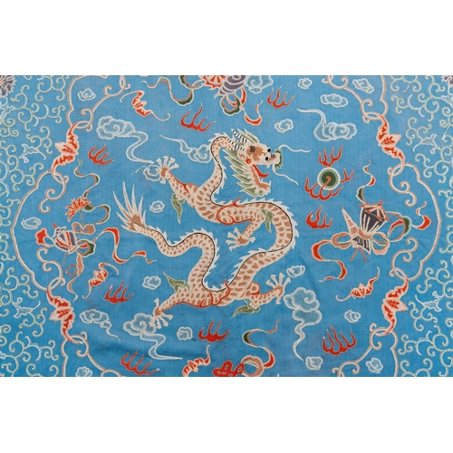 818 - A Chinese blue-ground embroidered silk panel with a dragon among bajixiang, 19th C.Dim.: 214,5 x 214... 