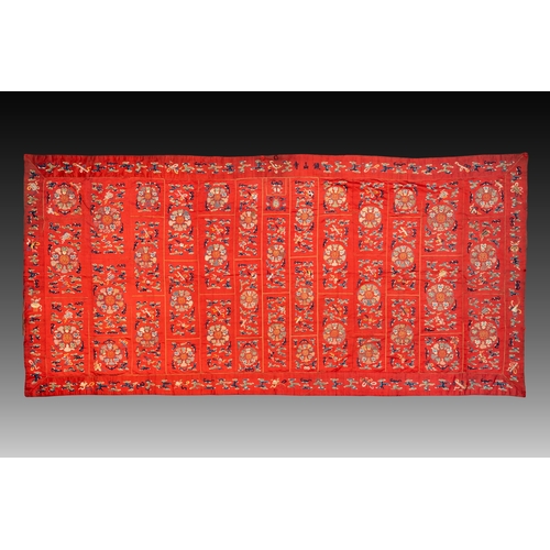 819 - A Chinese red-ground embroidered silk 'bajixiang' panel, Tie Shan Si mark, 19th C.Dim.: 253 x 122 cm... 